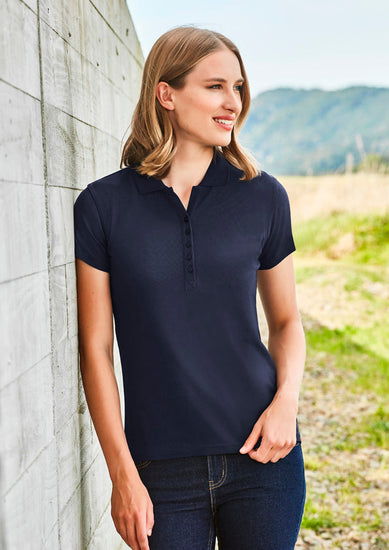 Image of a woman in a Pique Knitted Flat Collar Women's Polo during a professional seminar.