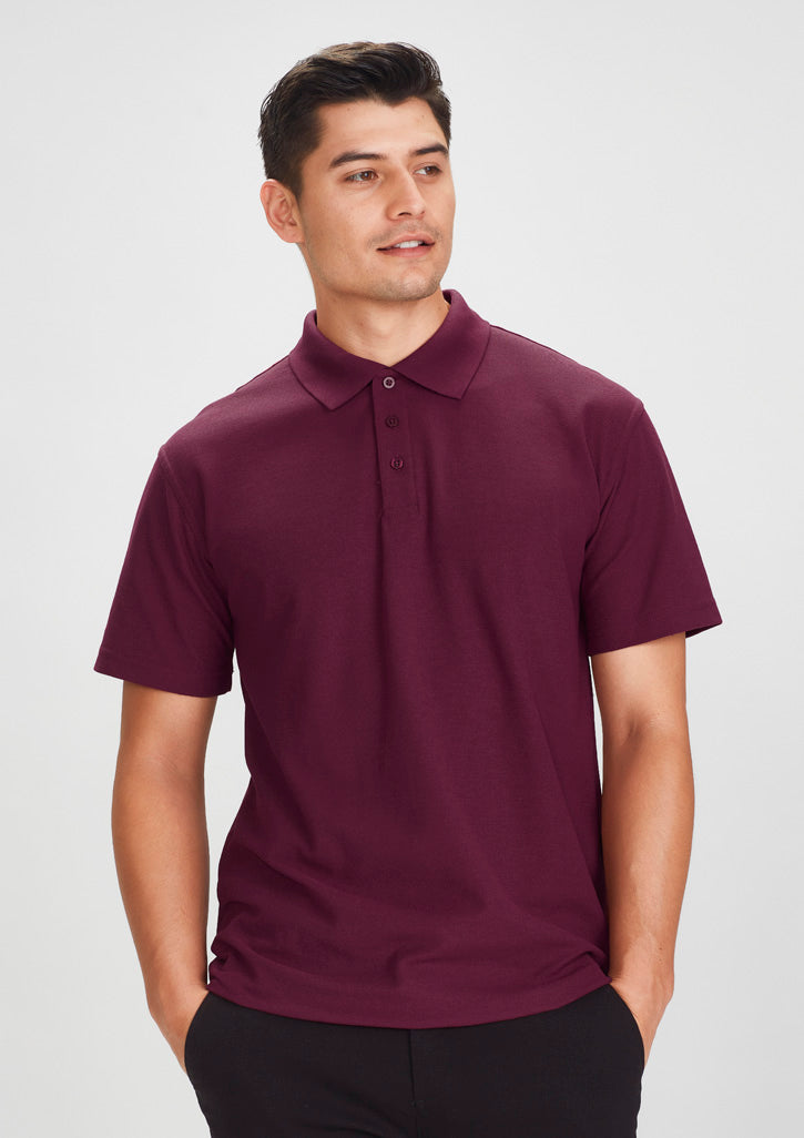 Image depicting a man in a Pique Knitted Flat Collar Men's Polo at a casual business meeting.